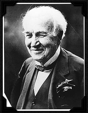 Photo-portrait of a smiling Thomas Edison.