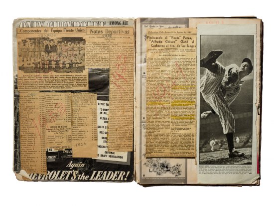 Interior photo of Martinez's LIFE magazine scrapbook. A large photograph of  Yankees pitcher Vernon “Lefty” Gomez in the middle of a pitch covers most of the page.