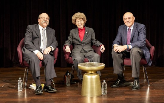 Photograph of panelists on stage, seated.