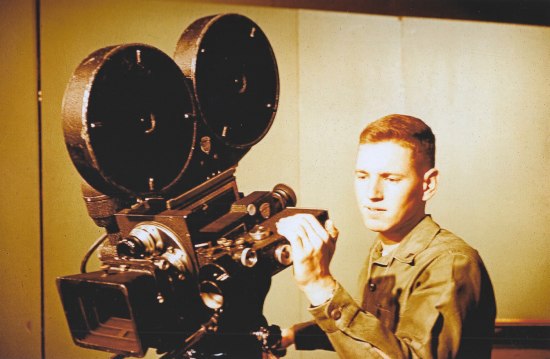 Photo of young man with film camera 
