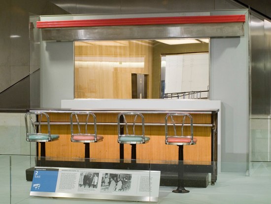 Photograph of the section of the Greensboro Woolworth's lunch counter that is part of the museum's collection and is currently on display on the museum floo
