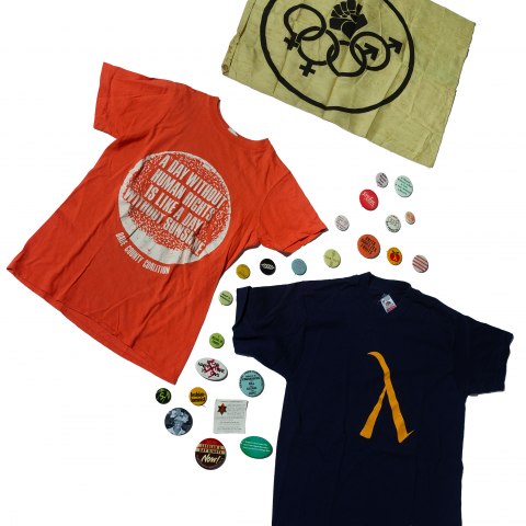 T shirts, buttons and other items are laid out over a white background