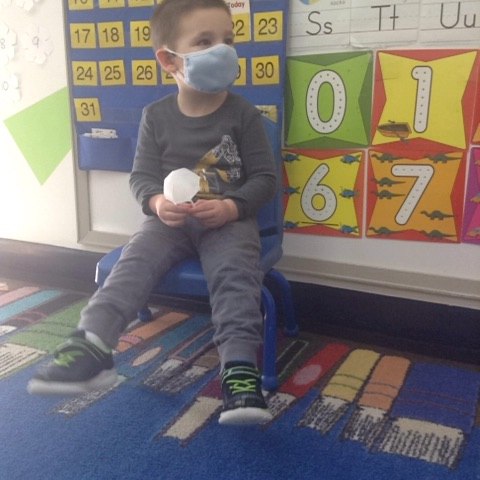 Boy in mask in preschool room